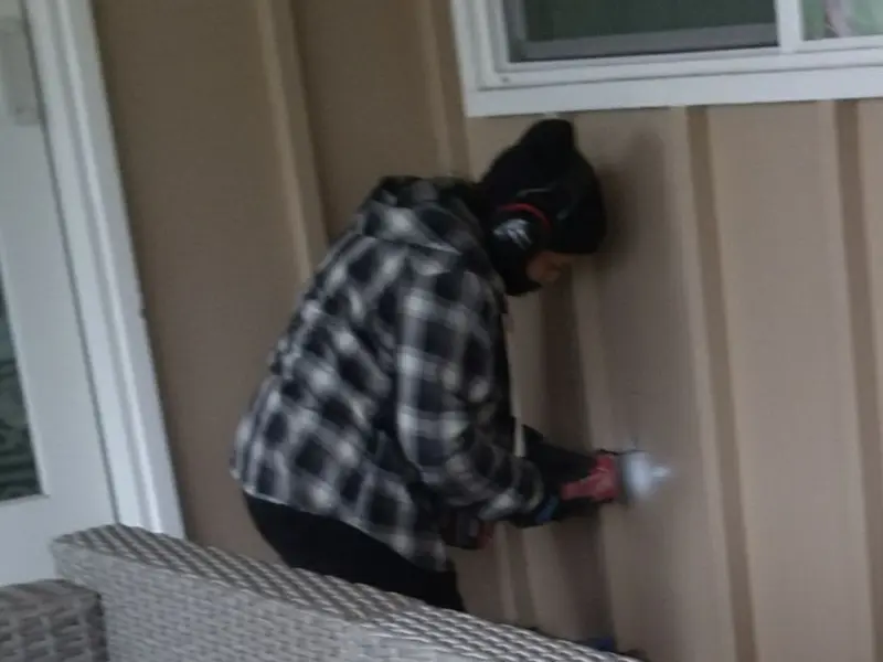 Professional electrician installing an exterior outlet in Williamstown